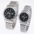 Detail view of silver stainless steel couple quartz watches with black dial and rhinestone bezel. - Silver Black Dial Men