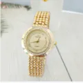 Detail view of the elegant gold quartz women watch featuring a rhinestone bezel and beaded strap. - Gold