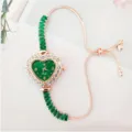Élégante montre pour femme en or rose en forme de cœur avec bracelet en cristal vert. - Vert