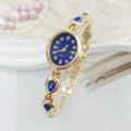 Close-up detail of women quartz watch with blue dial and teardrop crystal bracelet. - Blue