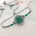 Montre quartz élégante pour femme avec cadran vert, strass étincelants et bracelet réglable. - Vert