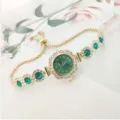 Detailed shot of a luxury women quartz watch with green dial, rhinestone bezel and adjustable pull bracelet. - Gold / Green