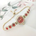 Women quartz watch with red dial, diamond-encrusted flower case, and adjustable chain strap. - Gold / Red