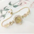 Close up detail of women quartz watch featuring rhinestone floral bezel and adjustable chain strap. - Gold Pink