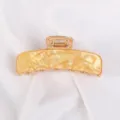 Elegante molletta per capelli dorata ricurva in acrilico ambrato per acconciature. - venatura ambra