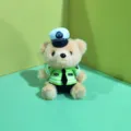 Close-up of cute plush bear toy wearing a traffic police uniform, mini hat and green shirt. - Police Bear