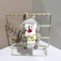 Cute plush rabbit pendant detail, fluffy stuffed animal holding sweet cake decor on shelf. - 12cm Colored Rope / Light Brown
