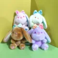 Plushase Spielzeug Detail mit weichem Fell, funkelnden Augen und bunter Schleife. - Gemischtes Sortiment