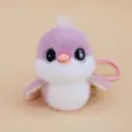 Close-up detail of cute purple and white titmouse plush doll pendant with shiny big eyes. - Titmouse - Purple