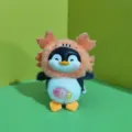 Cute penguin plush toy pendant detail showing vinyl face and fluffy monster hat design. - Bead Chain Style / Orange