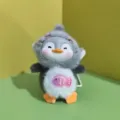 Close-up detail of cute penguin plush pendant, soft plush body and vinyl face design. - Bead Chain Style / Gray