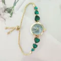 Elegant gold quartz watch with green heart crystal charms and adjustable sliding chain. - Gold Case Green Dial