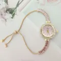 Elegante reloj de cuarzo dorado para mujer con esfera rosa y pulsera deslizante. - Rosa