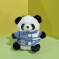 Cute panda plush toy pendant detail, featuring a blue knitted sweater with buttons. - Black and Blue Sweater