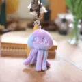 Close-up detail of cute purple gradient jellyfish plush keychain, soft toy bag charm accessory. - 17cm Keychains / Purple