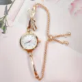 Rose gold quartz watch detail featuring a sparkling rhinestone bow and adjustable chain strap. - White