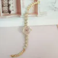 Women's rhinestone quartz watch with flower case and sparkling crystal bracelet. - Gold Pink