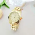 Gold rhinestone quartz watch detail view, elegant metal strap and sparkly dial markers. - Women / Gold