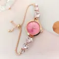 Detailaufnahme der roségoldenen Damenuhr Quarzuhr mit rosa Kristall Herz Armband. - Roségold Rosa