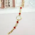 Elegante Damen Quarz Armbanduhr mit roten Edelsteinen und glitzernden Kristalldetails. - Gold Rot