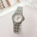 Close-up detail of the silver rhinestone women quartz watch, sparkling crystal bezel and steel strap. - Silver Pink
