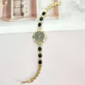 Modische Luxus Damen Quarzuhr mit schwarzen Tropfensteinen und goldenem Strass Armband. - Goldschwarz