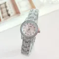 Detail view of a luxury rhinestone-studded quartz women's watch with pink dial and metal strap. - Silver Pink