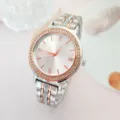Detail shot of elegant women quartz watch featuring shimmering rhinestones and two-tone strap. - Two-tone Rose Gold