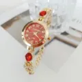 Gold-tone women's quartz bracelet watch featuring a striking red dial and red gemstone accents. - Red