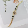 Goldfarbene Damen Quarzuhr mit schwarzen Blumenblattgliedern und Strass Armband Design - Gold Schwarz