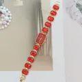 Red crystal quartz watch with gold-toned metal link band, elegant fashion ladies timepiece. - Gold Red