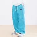 Men's casual corduroy wide leg pants detail view showing the textured blue fabric and drawstring. - Sky Blue