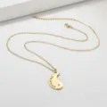 Close-up detail of the gold-plated stainless steel necklace with engraved little sis pendant. - Little Sis Half Heart Gold (N1507-A)