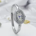 Detailed close-up view of the elegant silver oval quartz bangle watch with Roman numerals. - Silver Case White Dial