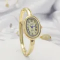 Golden oval quartz watch with Roman numerals and bangle bracelet for women elegant style - Gold Case Gold Dial