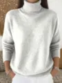 Detail view of the soft knitted turtleneck sweater texture and cozy fabric closeup. - S / Ash Grey