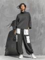Detailed view of the women's dark grey turtleneck sweater and contrast pocket cargo pants. - S / Top And Bottom / Gray