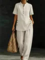 Detailed view of the casual linen two-piece set featuring a button-up shirt and wide-leg pants. - S / Apricot