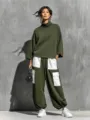 Detailed view of women's olive green turtleneck sweatshirt and white pocket cargo pants outfit. - S / Top And Bottom / Army Green