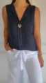Detail view of the women's sleeveless V-neck linen casual shirt with decorative button. - S / Navy Blue