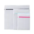 Set of 3 white mesh laundry bags with colorful zippers for delicate clothes washing and storage. - 3-Piece Honeycomb Mesh Set