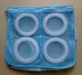 Detail view of blue mesh shoe washing bag with four white circular frames and zipper. - Blue