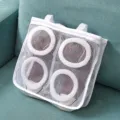 Detail view of white mesh shoe wash bag with hanging straps for laundry drying and protection. - White