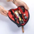Wasserdichte Kosmetiktasche in Herzform mit rotem Innenfutter und mehreren Fächern. - Schwarz + Rot