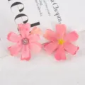 Close-up detail of pink artificial fabric flower heads, perfect for DIY crafts and decor. - Style 7