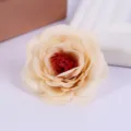 Close-up detail of artificial champagne rose flower head with vibrant red center for decor. - Style 8