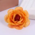Close-up view of artificial orange rose flower head showing detailed fabric petals and rich color. - Style 10