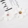 Macro detail shot of white artificial silk flower heads featuring fine stamen textures. - Style 15