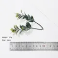 Detailed close-up shot of artificial plastic eucalyptus leaves, showing realistic texture and size. - Style 6