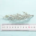 Close-up view of artificial frosted plant branch displayed with measurement ruler for sizing. - Style 14